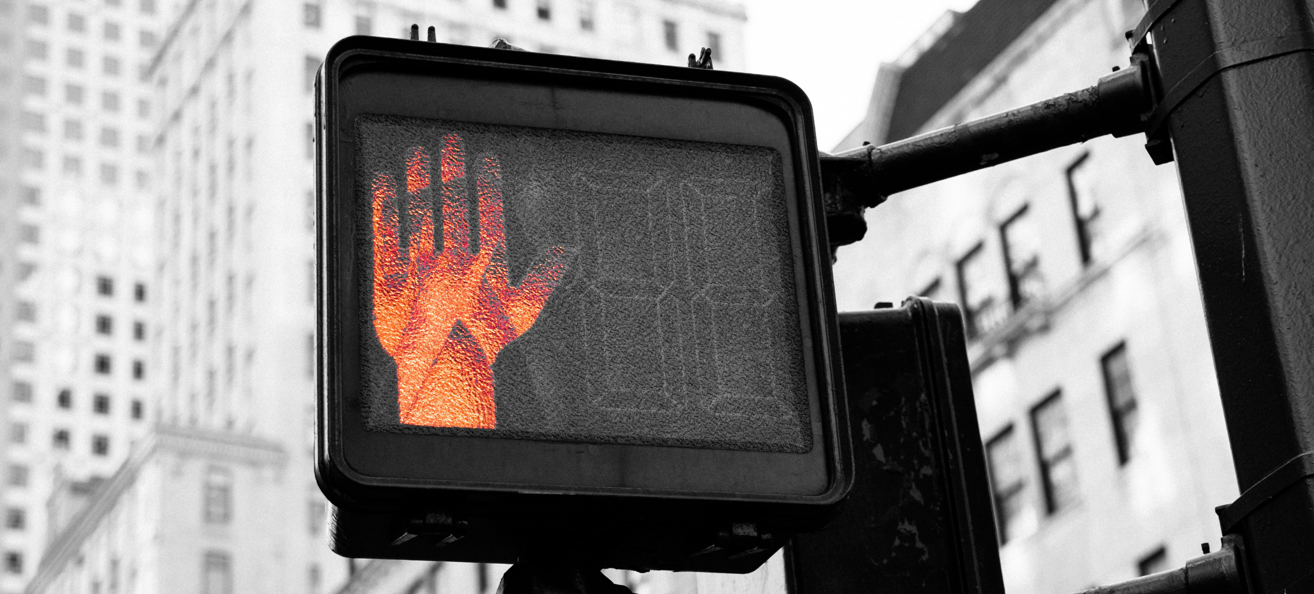 pedestrian crosswalk sign set to orange don't walk hand