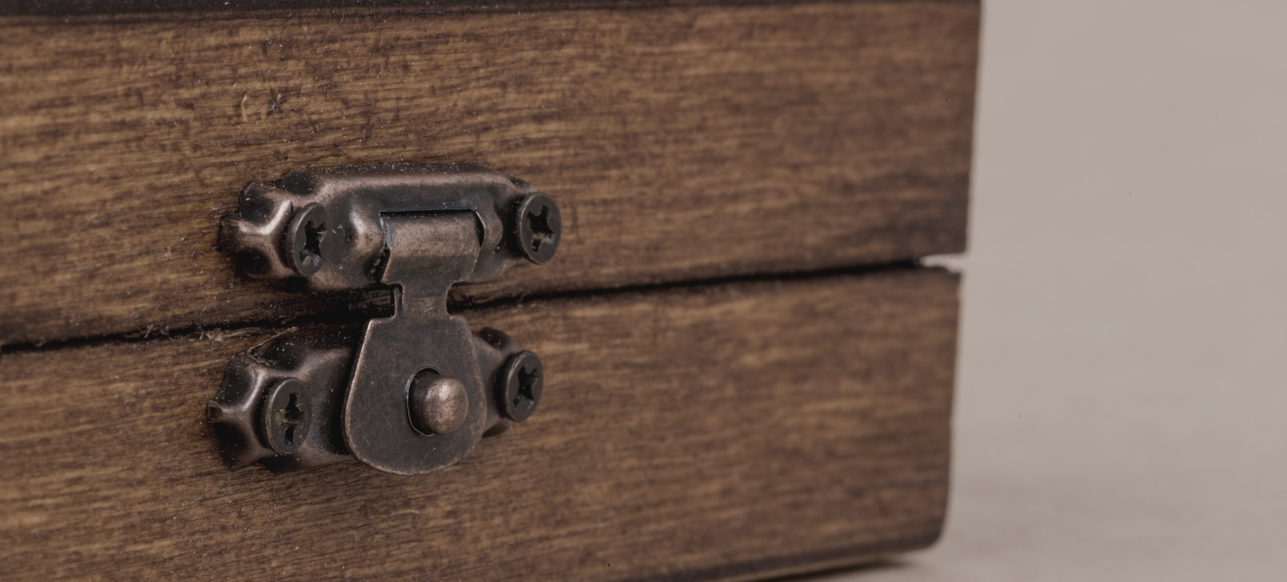 Close-up photo of a wooden box with a metal latch