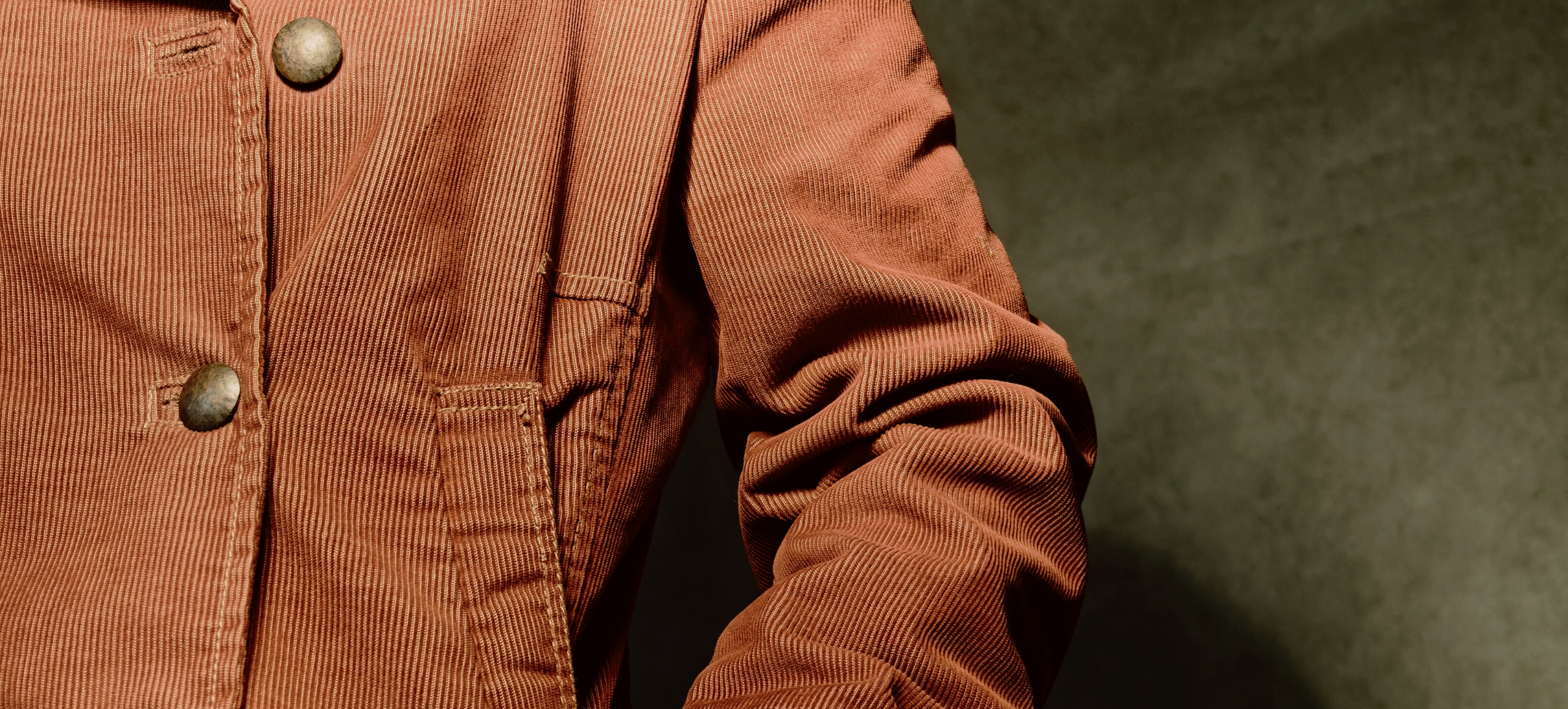 Photo of a person wearing a brown corduroy coat
