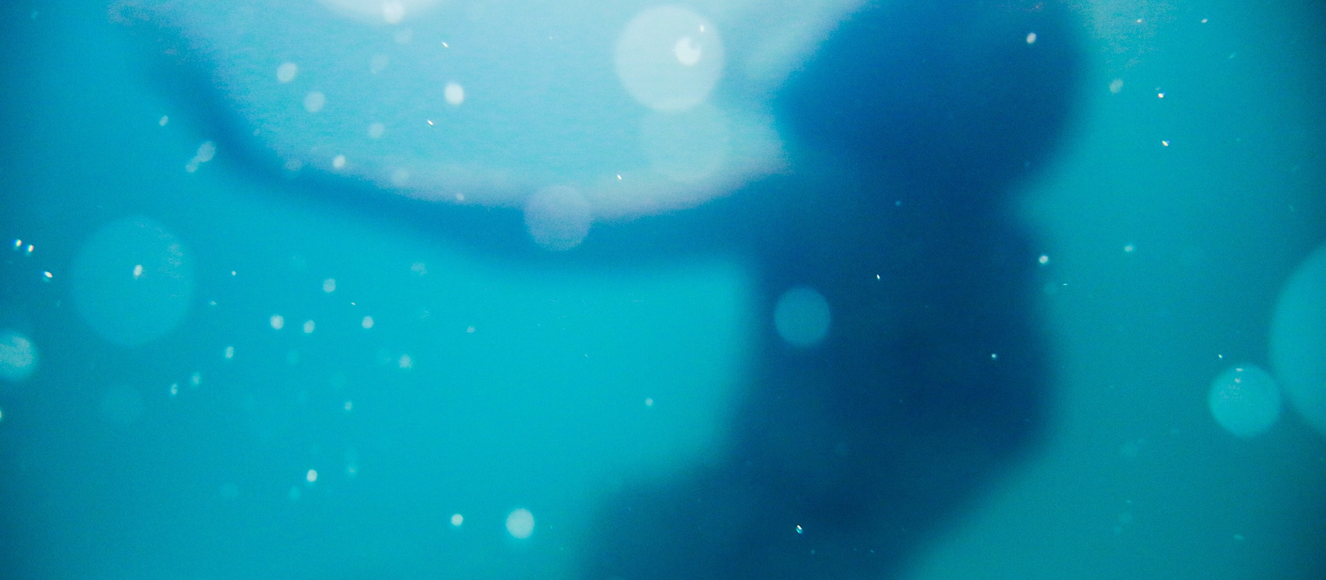 Photo of a woman's blurry silhouette underwater